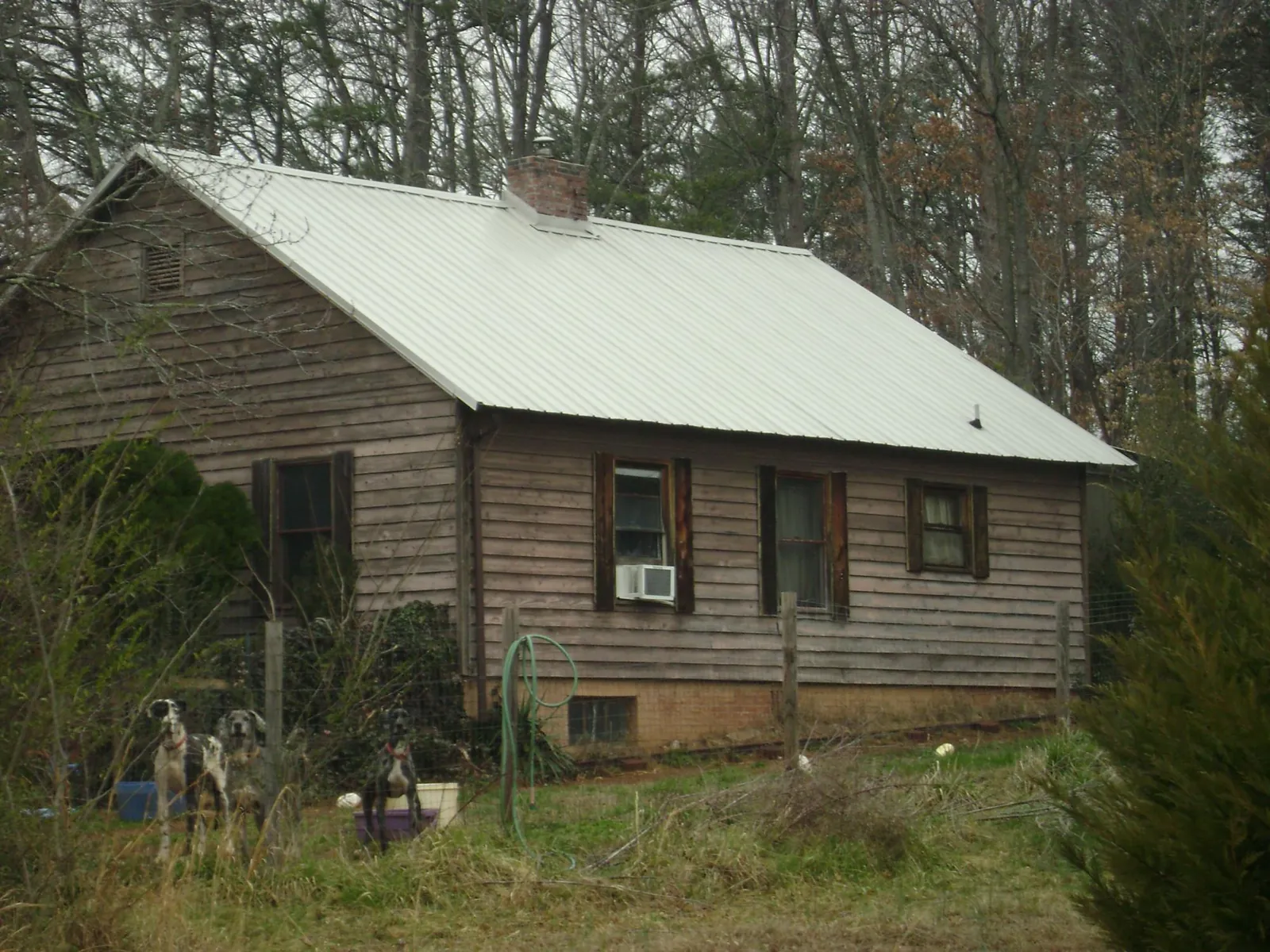White metal roof on an old wood sided farmhouse, from a Metal Roof Installation job in Merrimack